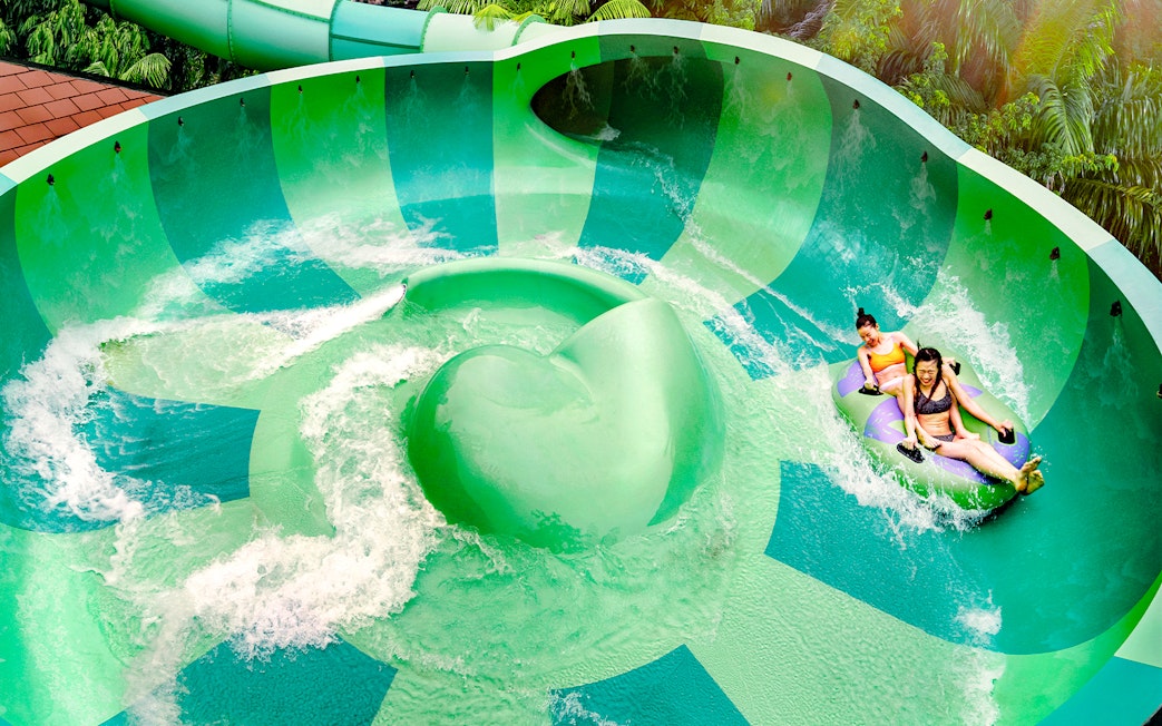 Visitors enjoying a water slide at Adventure Cove Waterpark™.