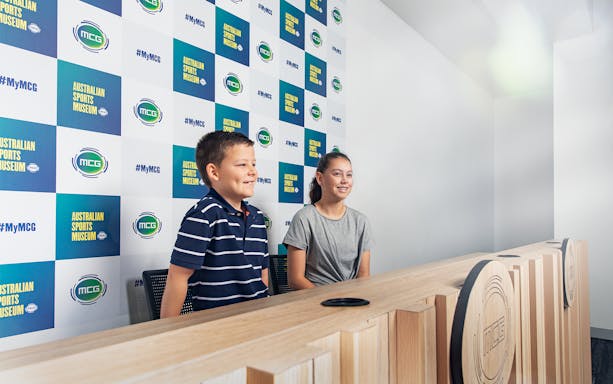 Children at Melbourne Cricket Ground press room during guided tour.