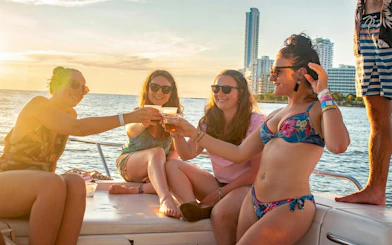 Tourists enjoying a sunset boat party in Cartagena's Bay.