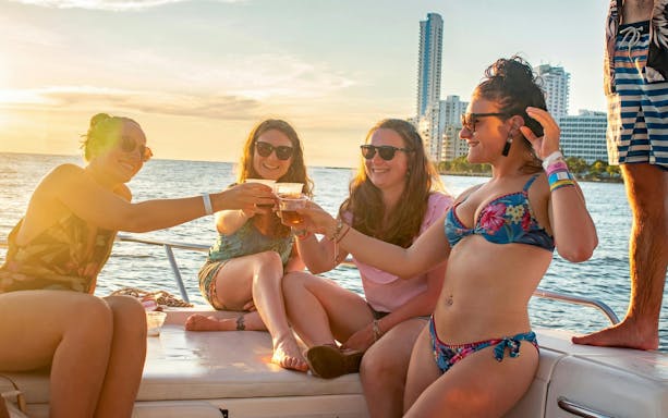 Tourists enjoying a sunset boat party in Cartagena's Bay.