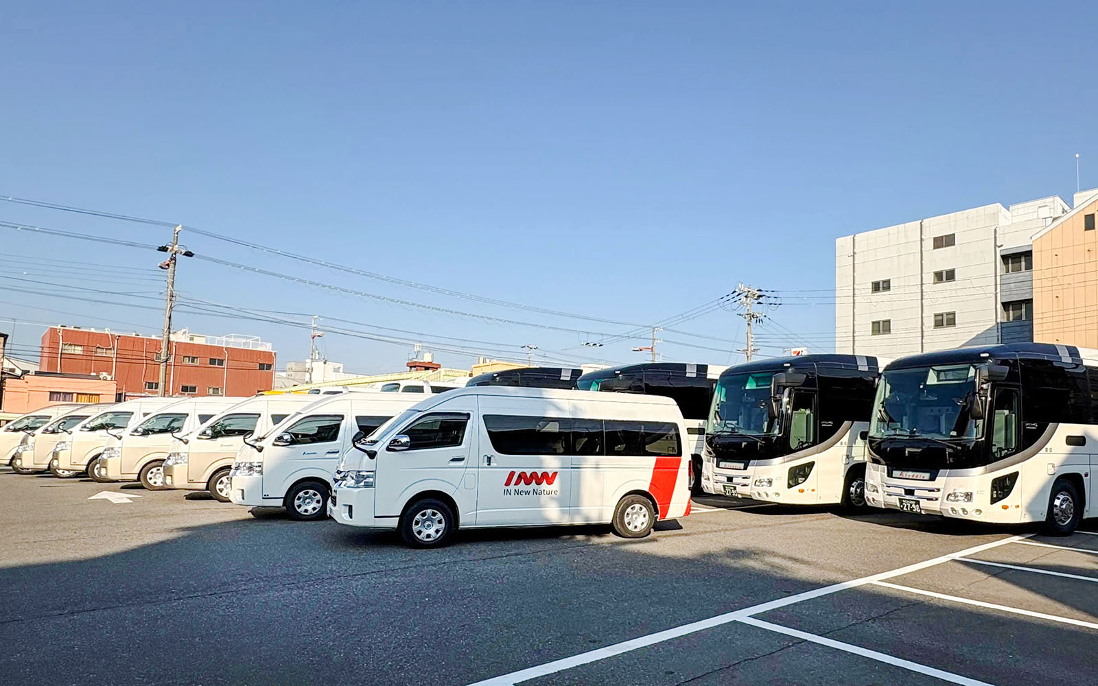 Kansai Airport shuttle vans and buses in parking lot for hotel drop-off service.