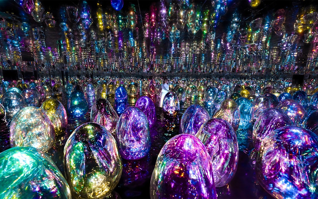 Colorful illuminated orbs in TeamLab Phenomena Abu Dhabi exhibit.