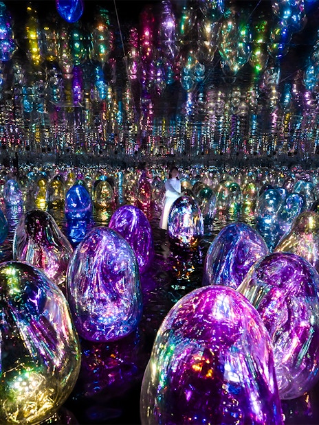 Colorful illuminated orbs in TeamLab Phenomena Abu Dhabi exhibit.