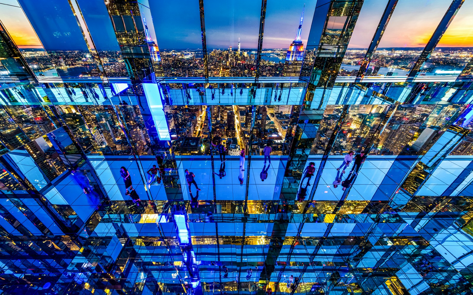 Guests enjoying panoramic night views from Summit One Vanderbilt, New York City.
