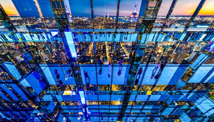 Guests enjoying panoramic night views from Summit One Vanderbilt, New York City.