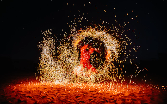 Performer spinning fire in a desert show, Dubai.