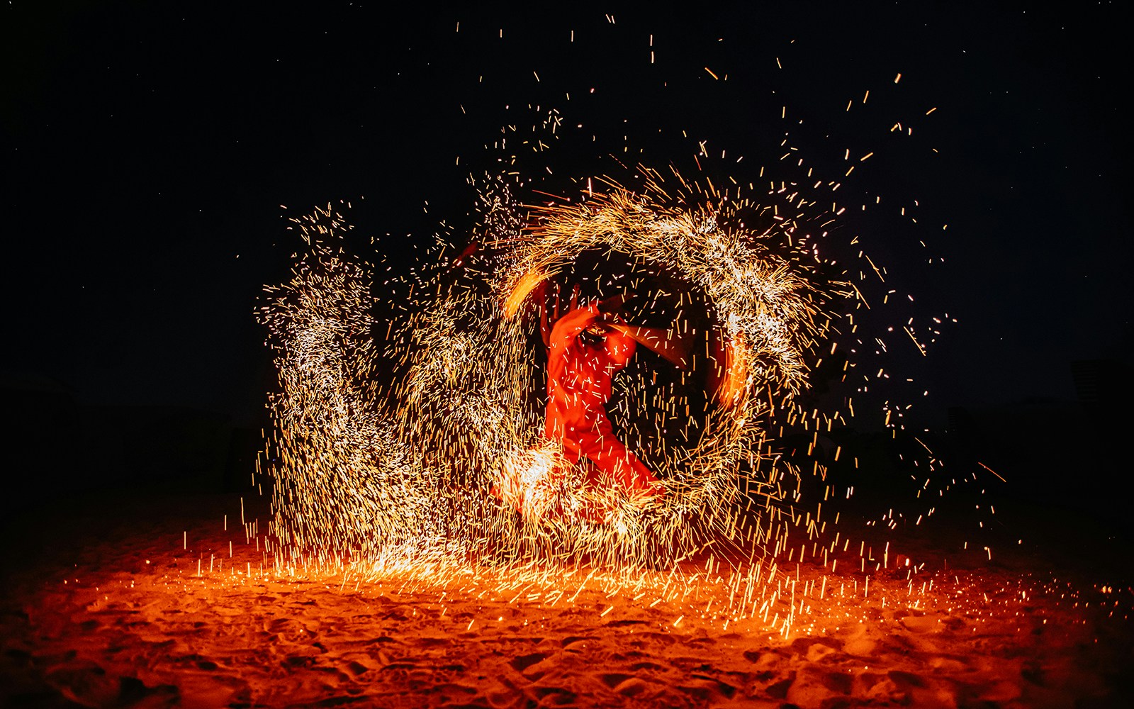 Performer spinning fire in a desert show, Dubai.