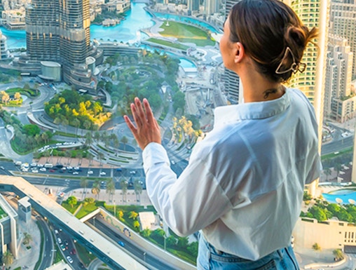 Person enjoying cityscape view from Sky Views Edge Walk in Dubai.