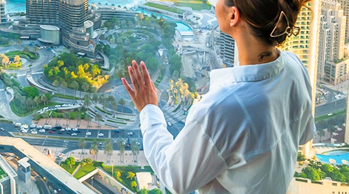 Person enjoying cityscape view from Sky Views Edge Walk in Dubai.