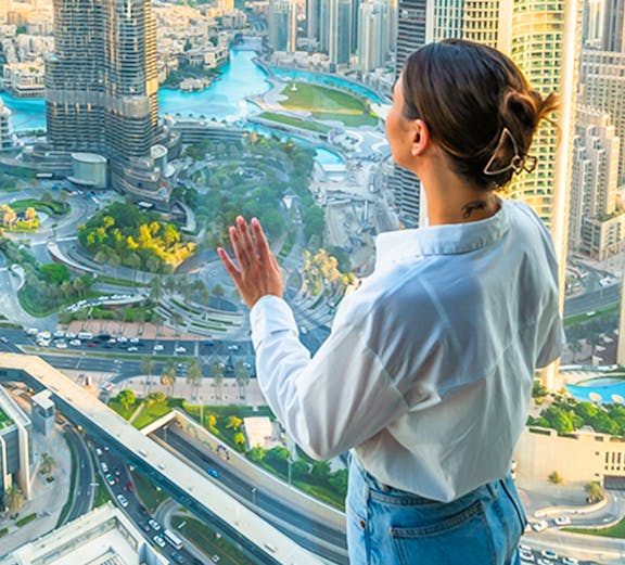 Person enjoying cityscape view from Sky Views Edge Walk in Dubai.
