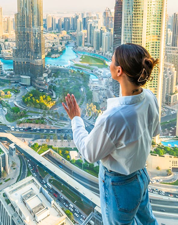 Person enjoying cityscape view from Sky Views Edge Walk in Dubai.