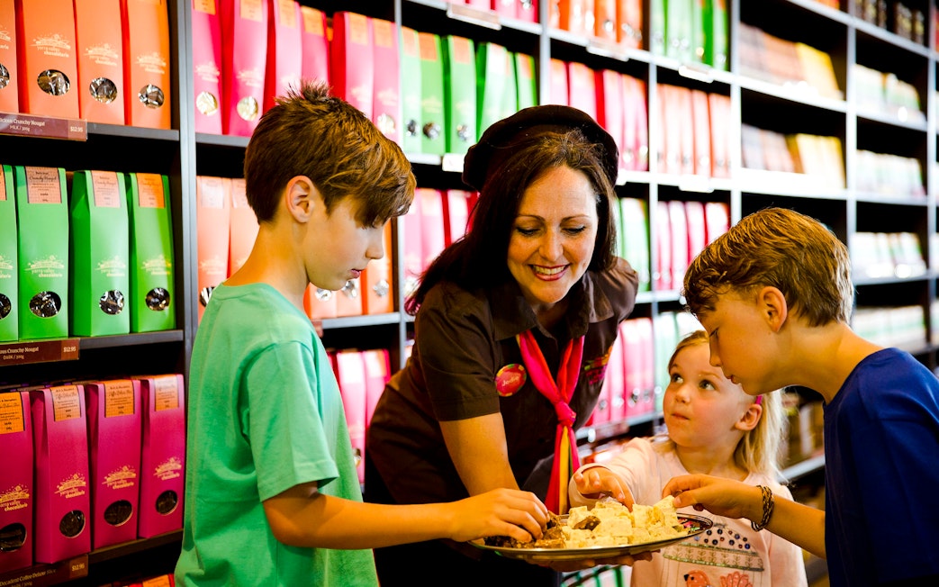 Children sampling chocolates with a guide at Yarra Valley Chocolaterie Ice-Creamery.