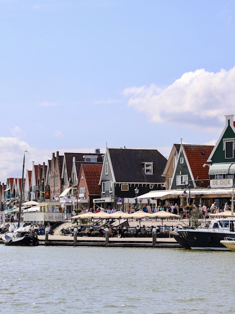 Volendam harbor with traditional Dutch houses and fishing boats.
