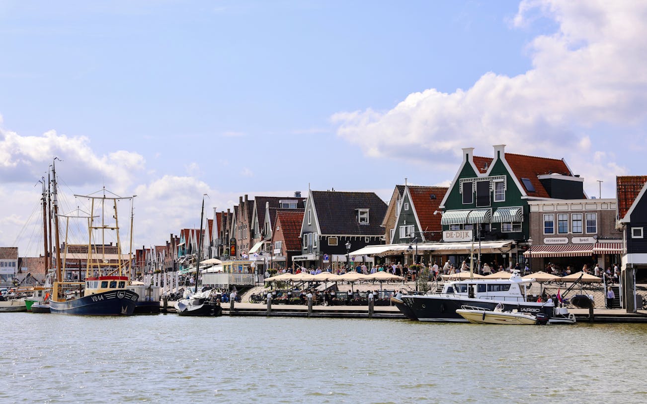 Volendam harbor with traditional Dutch houses and fishing boats.