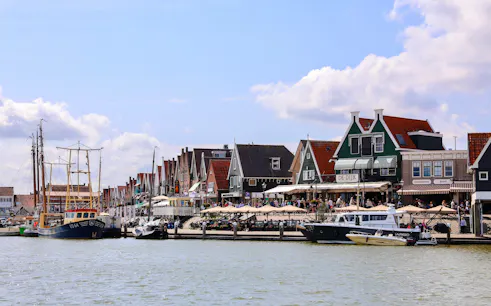 Volendam harbor with traditional Dutch houses and fishing boats.