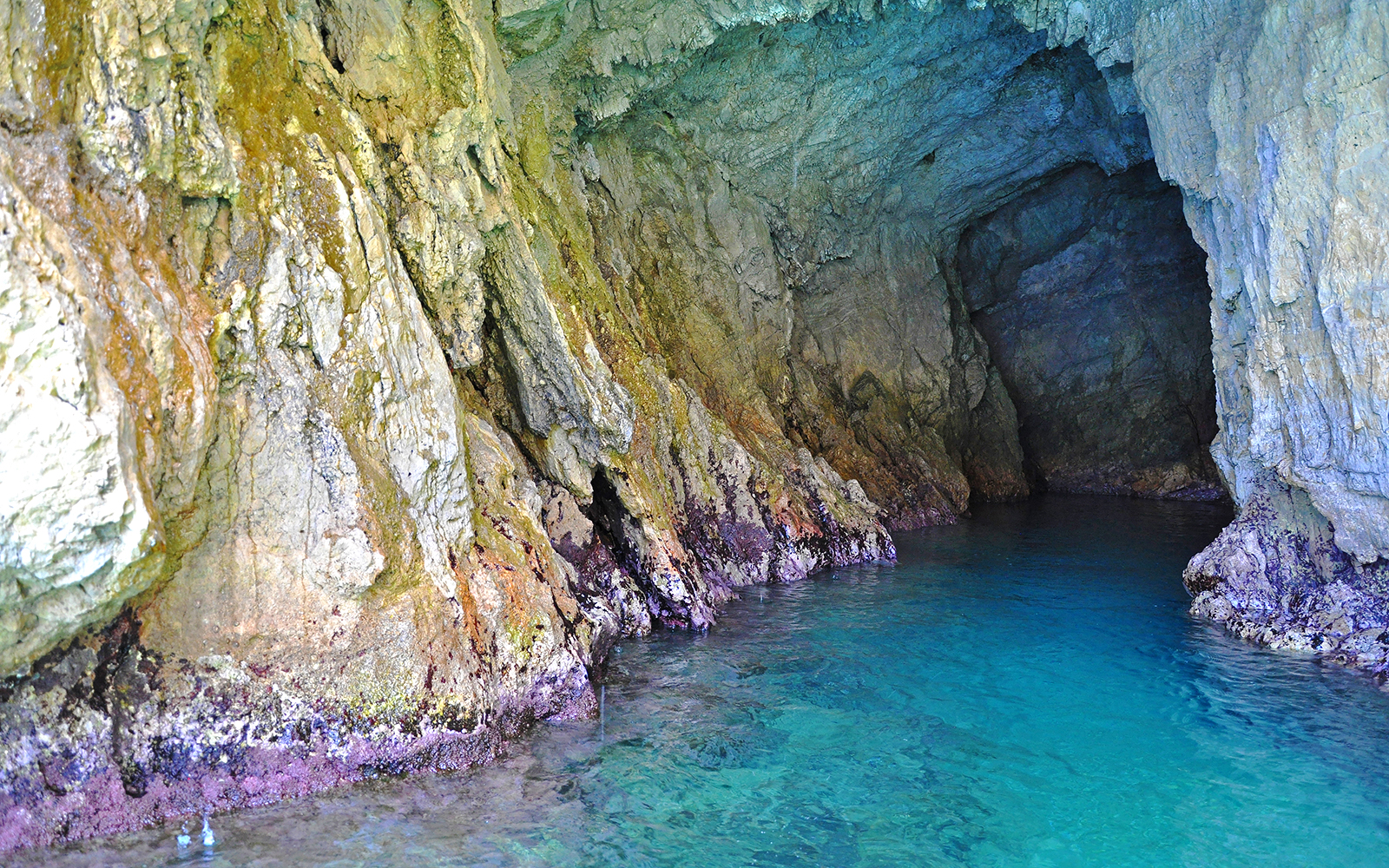 Emerald Grotto boat tour showcasing stunning sea cave formations on Rome to Amalfi day trip.