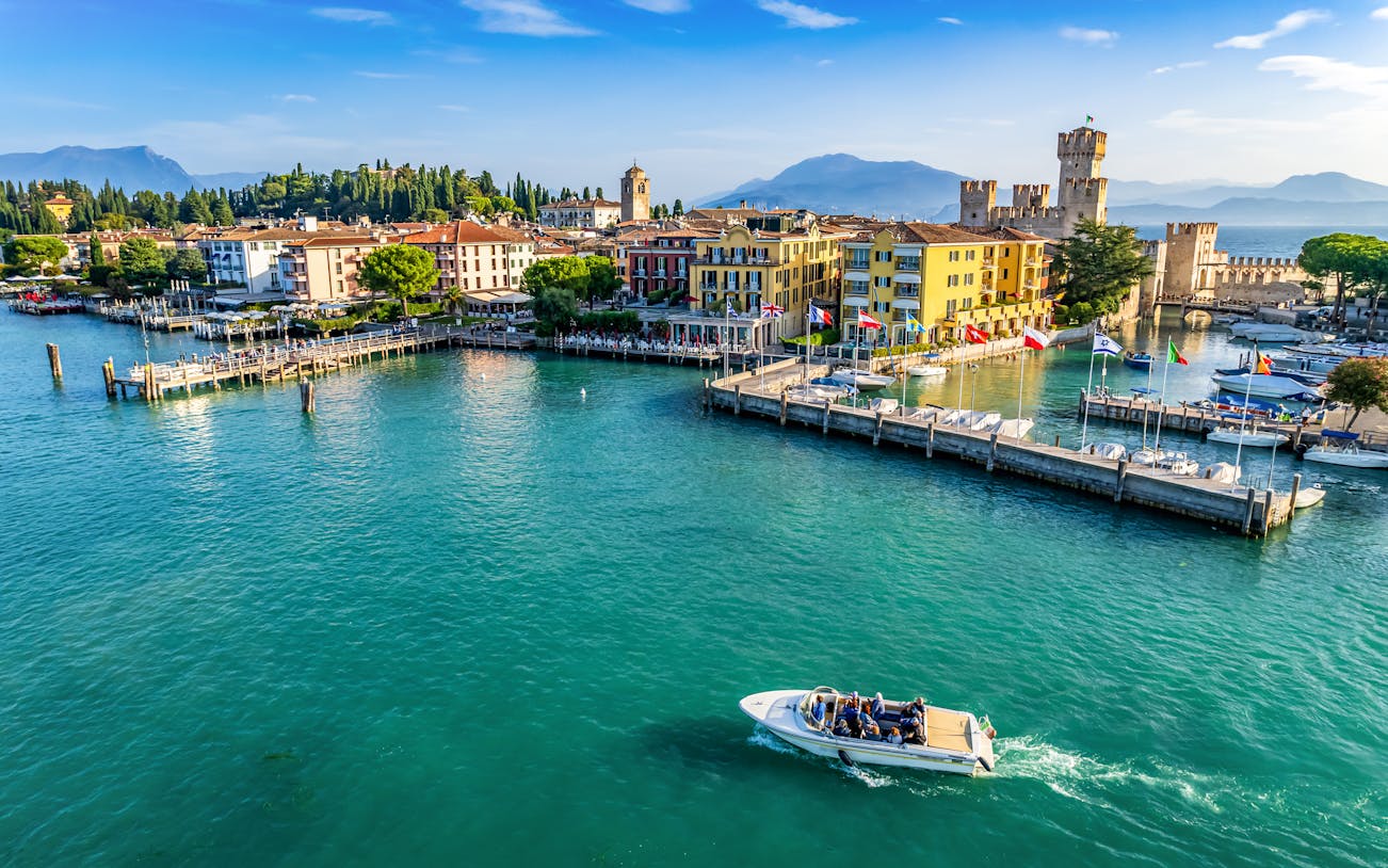 Aerial view of Sirmione with Scaliger Castle and boats on Lake Garda, Italy.