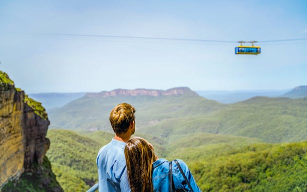 Couple viewing Scenic Skyway ride at Scenic World, Blue Mountains.
