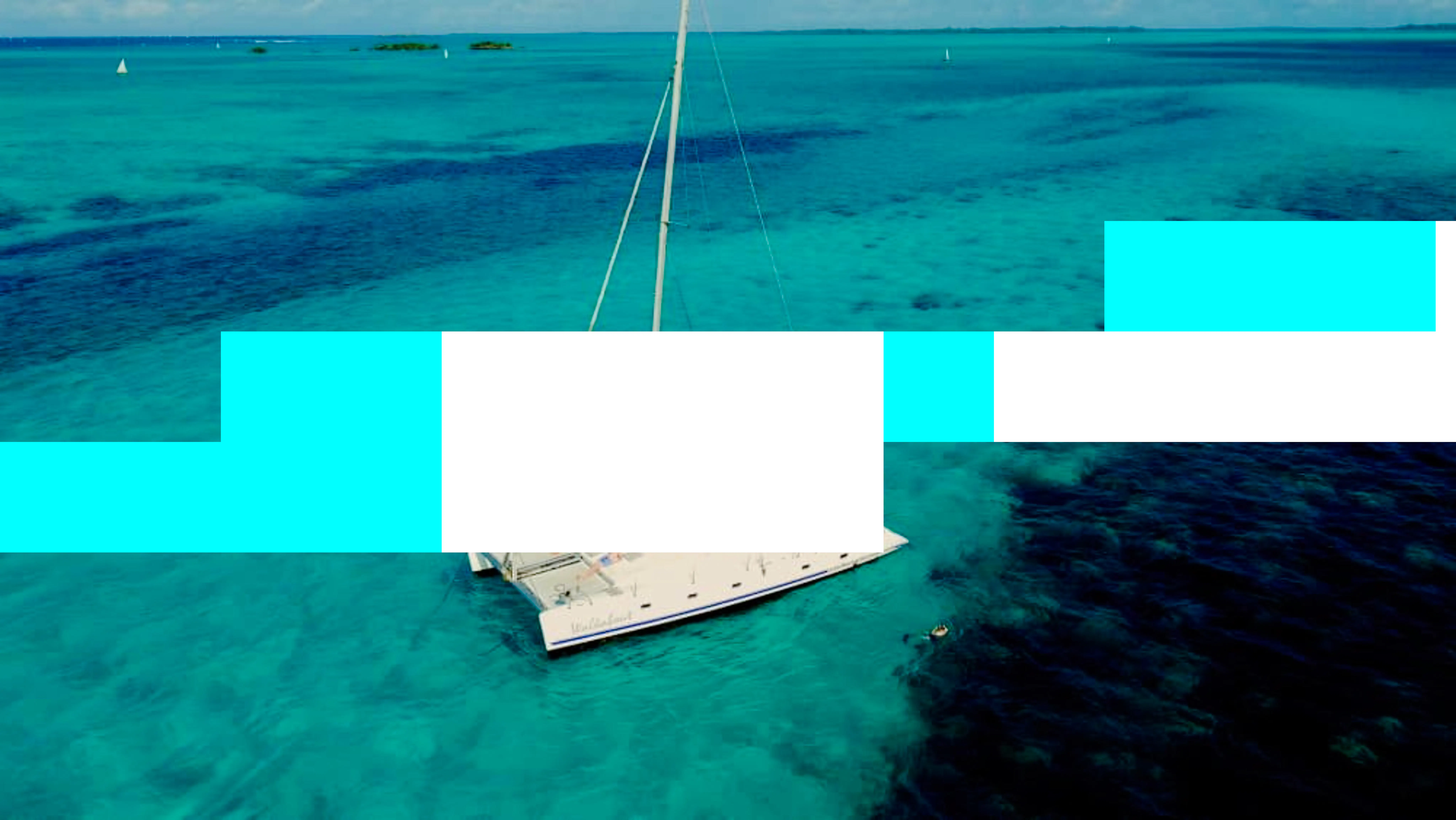 Sailboat on turquoise waters during a deep-sea fishing charter in Zanzibar.
