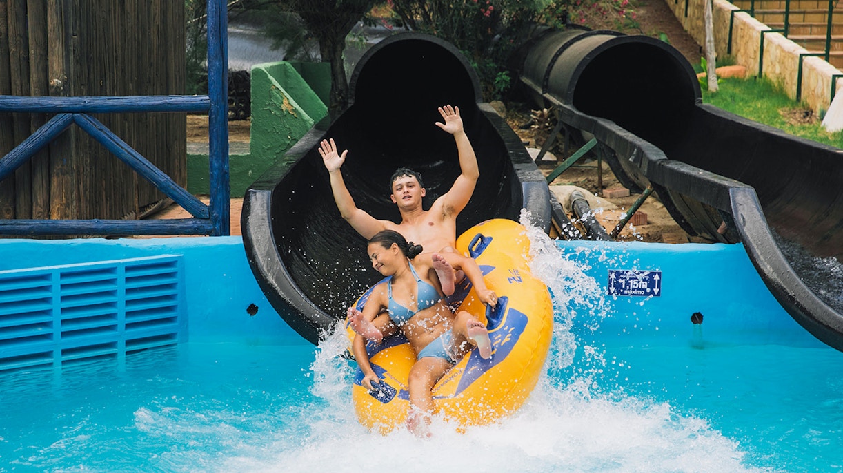 Visitors enjoying a water slide at Aqualandia Benidorm.