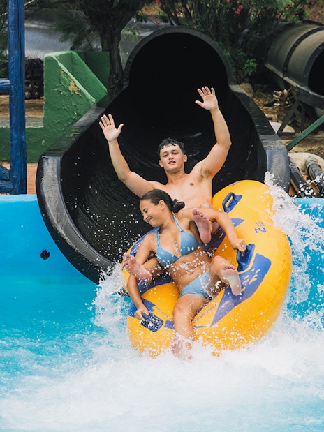 Visitors enjoying a water slide at Aqualandia Benidorm.