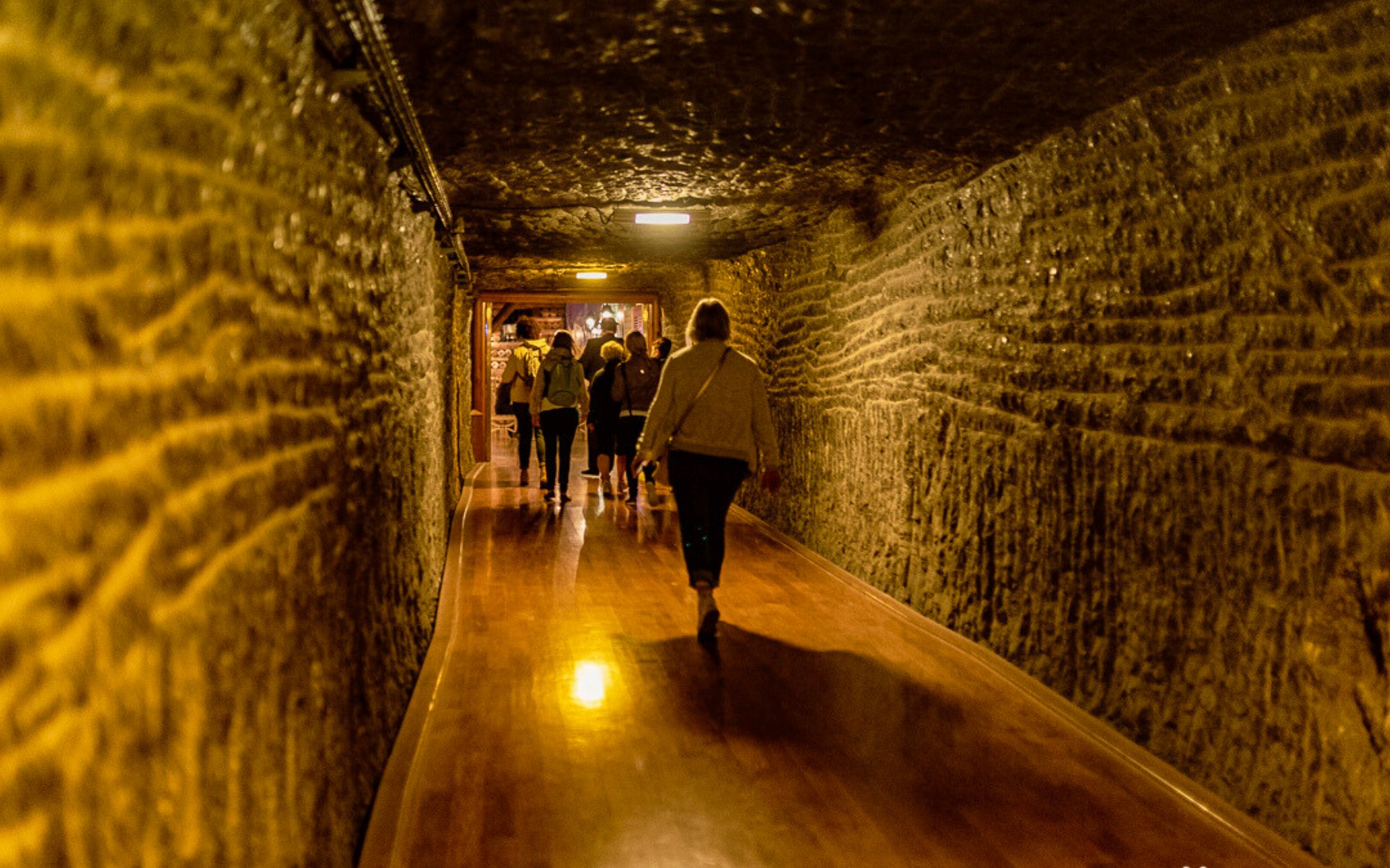Visitors walking through a tunnel in Wieliczka Salt Mine, Krakow, Poland.