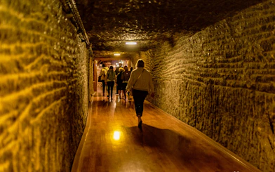 Visitors walking through a tunnel in Wieliczka Salt Mine, Krakow, Poland.