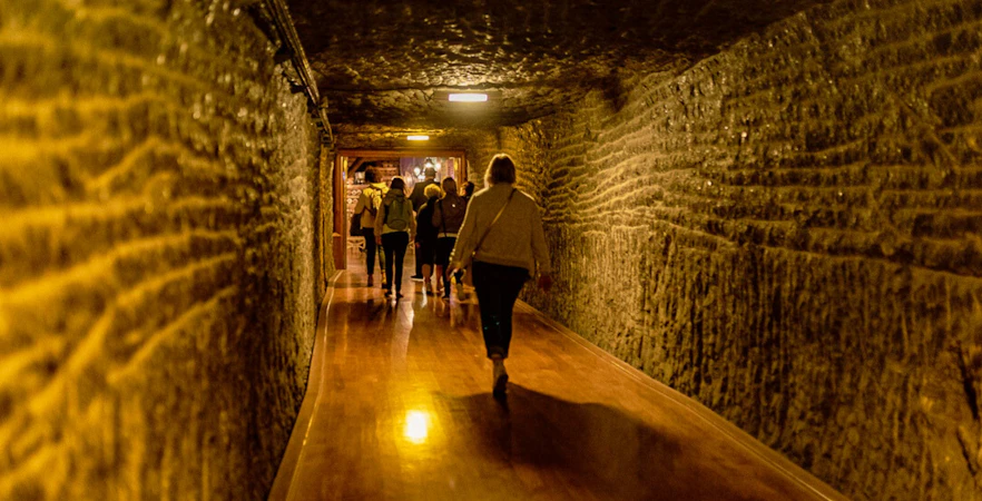 Visitors walking through a tunnel in Wieliczka Salt Mine, Krakow, Poland.