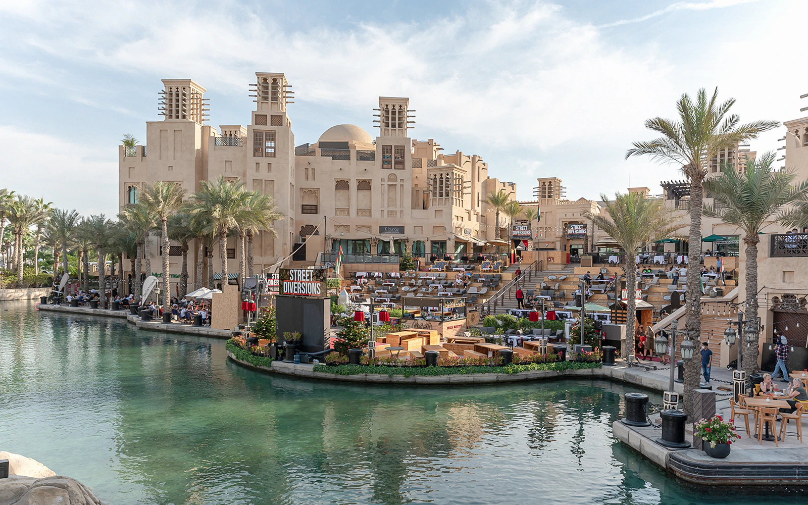 Madinat Jumeirah Festive Market with waterfront view and traditional architecture in Dubai.
