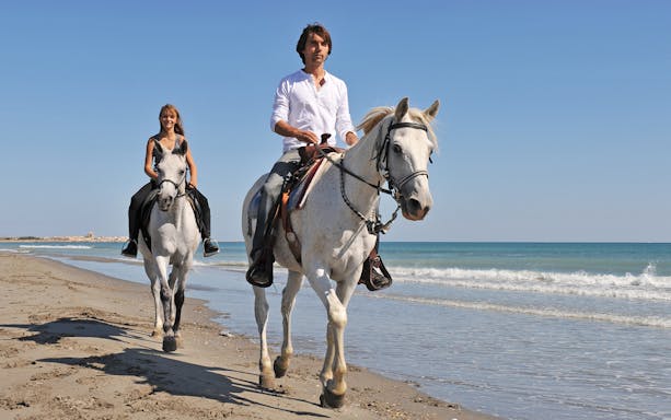 Horse riding along the beach in Antalya, Turkey.