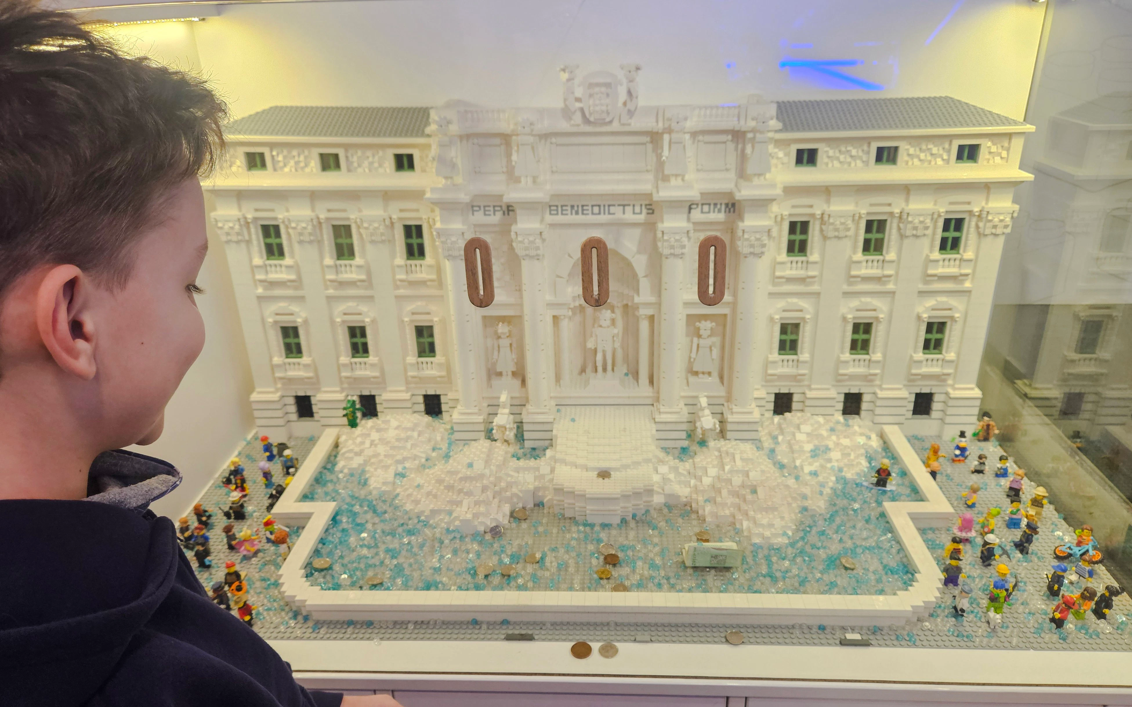 Trevi Fountain LEGO model at LEGO Museum in Prague with a child observing.