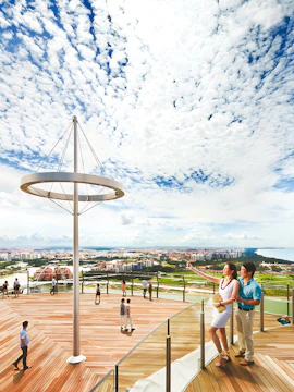 Visitors enjoying the view from Marina Bay Sands Sky Park in Singapore.