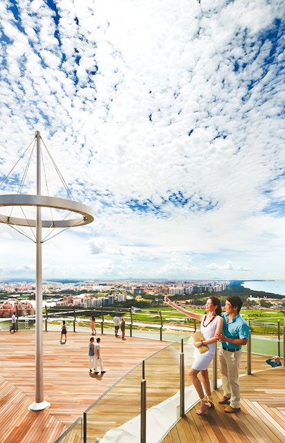 Visitors enjoying the view from Marina Bay Sands Sky Park in Singapore.