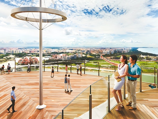 Visitors enjoying the view from Marina Bay Sands Sky Park in Singapore.