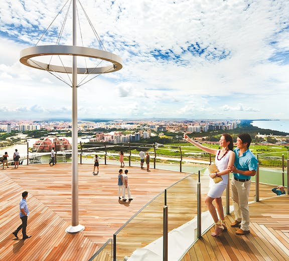 Visitors enjoying the view from Marina Bay Sands Sky Park in Singapore.