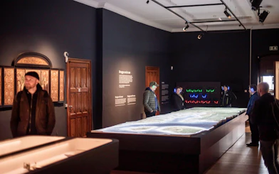 Visitors exploring an exhibit inside Bruges City Hall.
