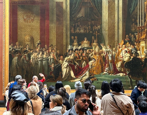 Tourists exploring the coronation of Napoleon at the Louvre Museum, Paris, France