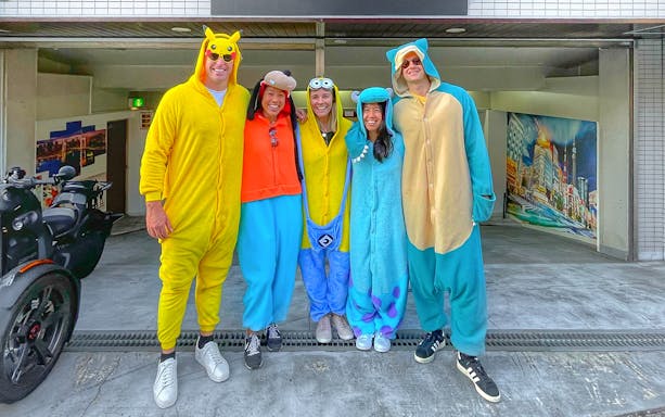 Group in character costumes ready for Tokyo street go-karting near Skytree.
