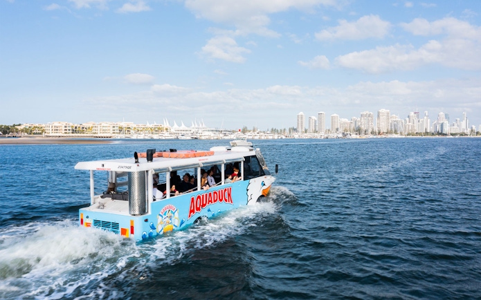 Aquaduck tour on Sunshine Coast water with city skyline in background.