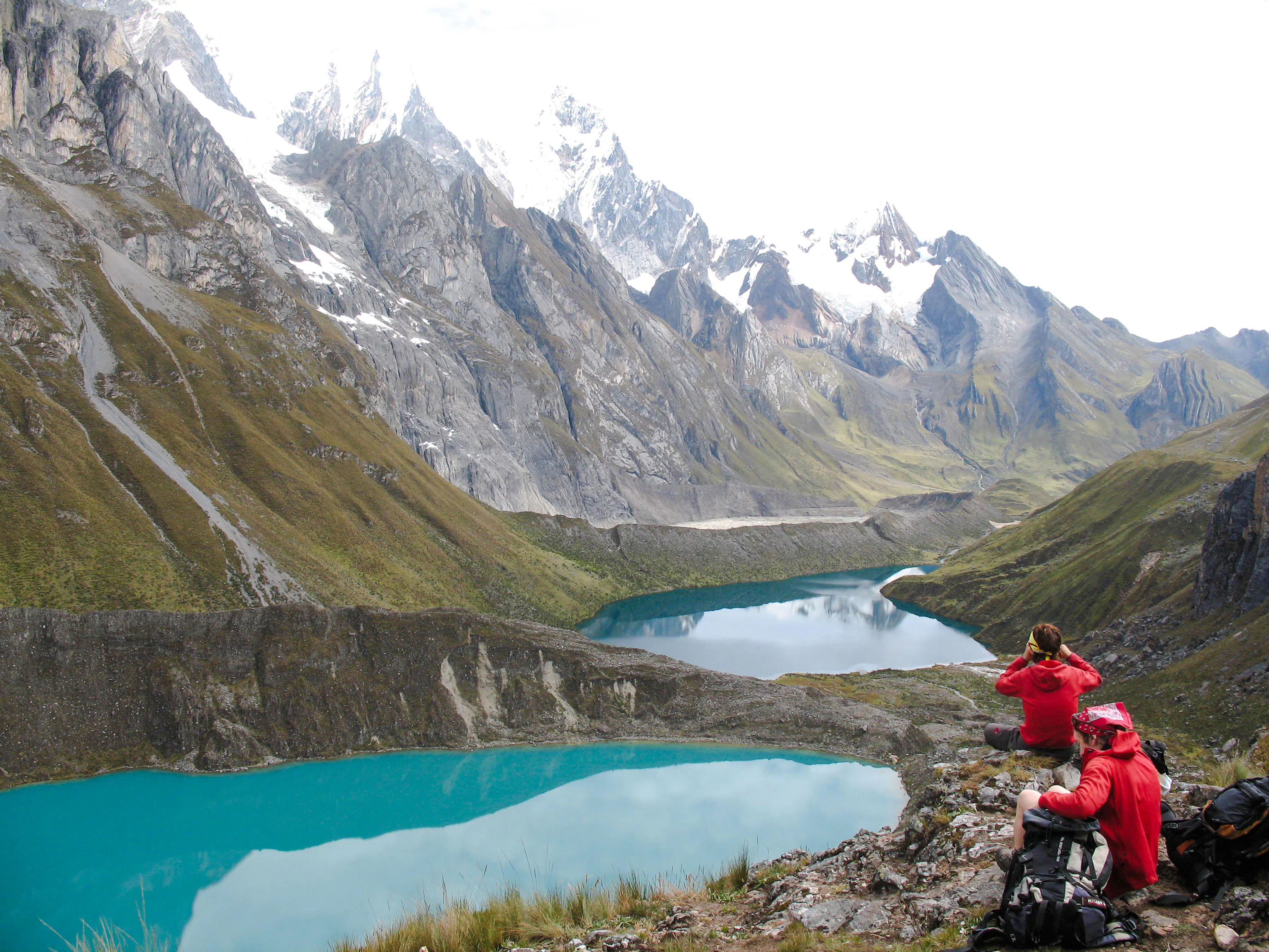 Trekking group overlooking turquoise lakes in Huayhuash, Cusco.