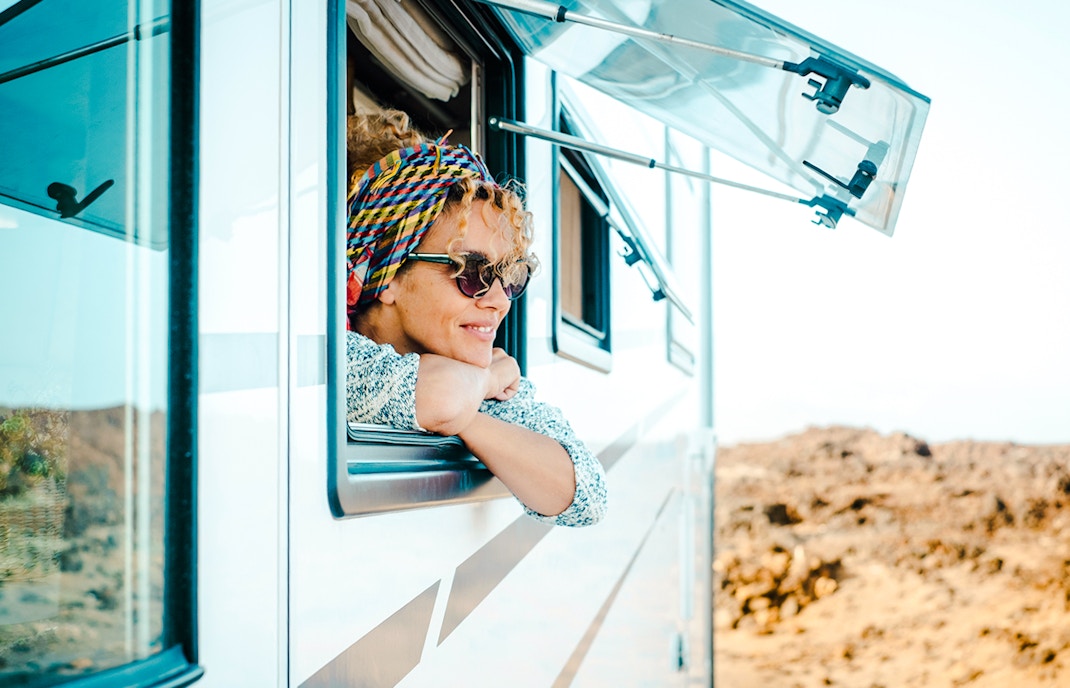 Woman peeping out of an RV window