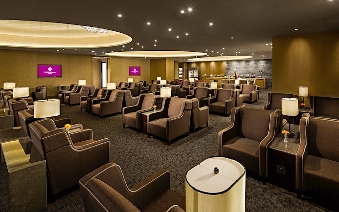 Plaza Premium Lounge seating area with armchairs and ambient lighting.
