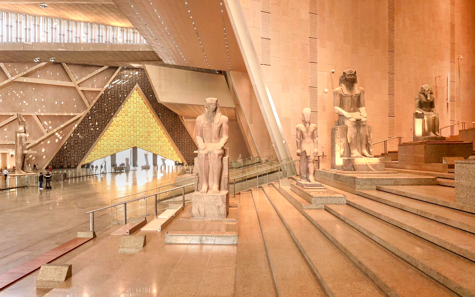Grand Egyptian Museum interior with ancient statues and architectural design.