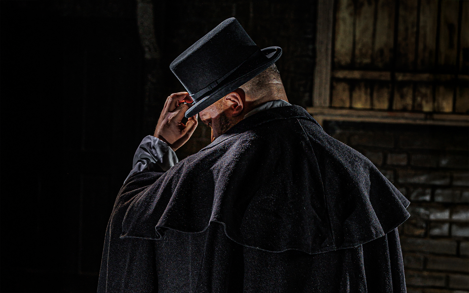 Man in dark cloak and top hat, representing Jack the Ripper at London Dungeon.