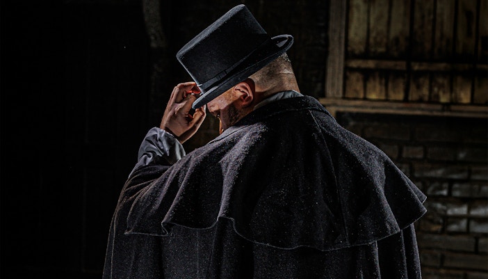 Man in dark cloak and top hat, representing Jack the Ripper at London Dungeon.