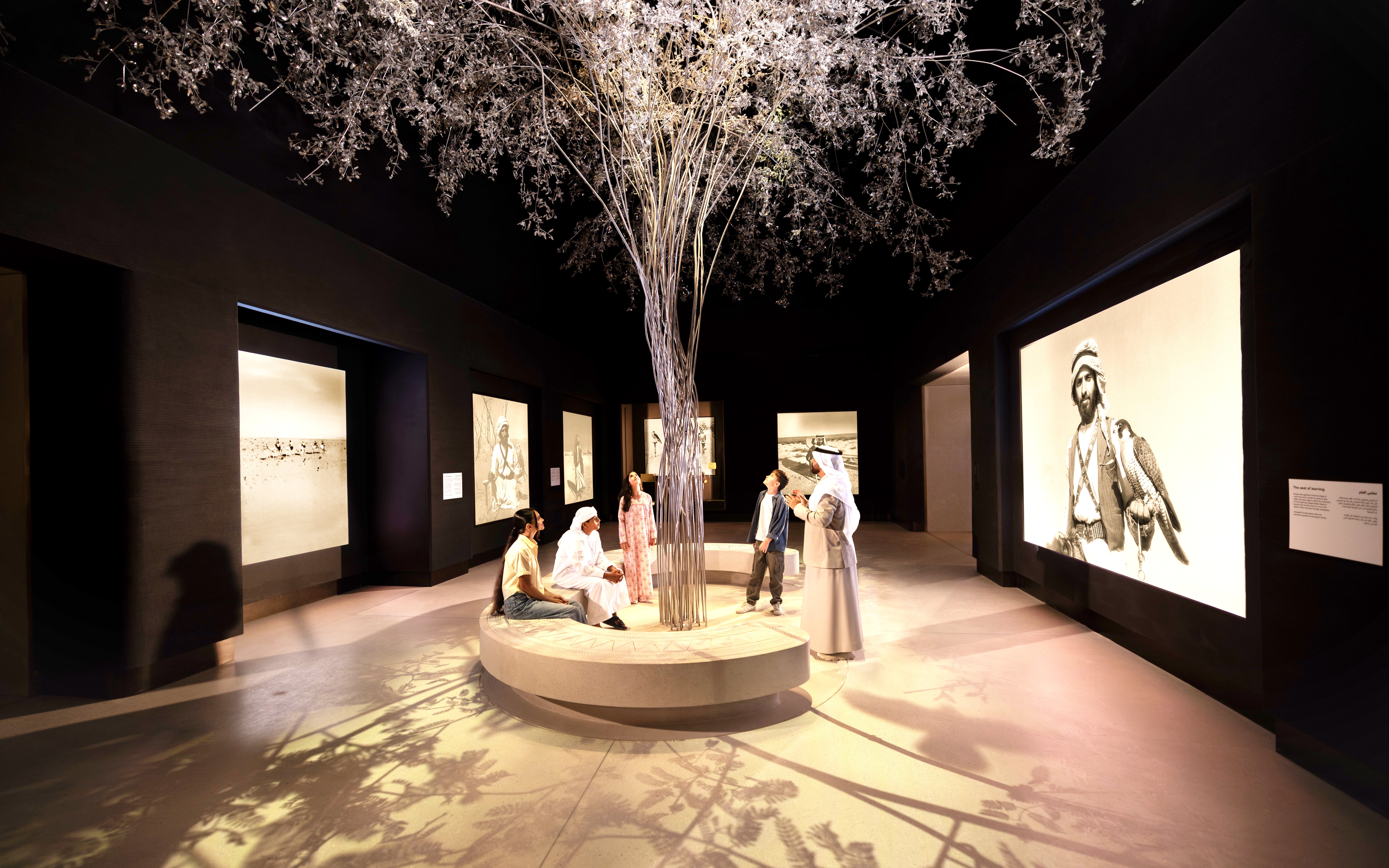 Visitors observing exhibits at the beginning exhibit, Zayed National Museum, Abu Dhabi.