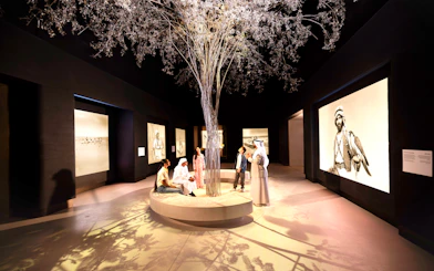 Visitors observing exhibits at the beginning exhibit, Zayed National Museum, Abu Dhabi.