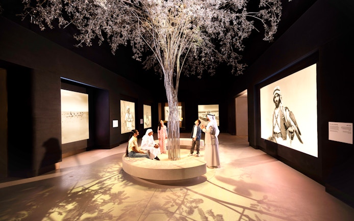 Visitors observing exhibits at the beginning exhibit, Zayed National Museum, Abu Dhabi.