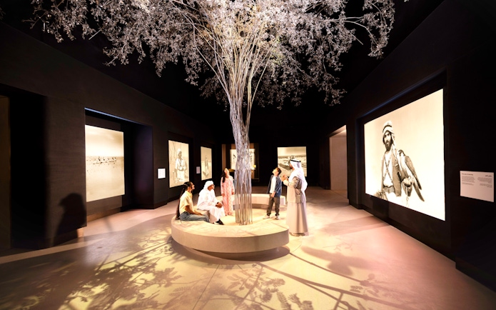 Visitors observing exhibits at the beginning exhibit, Zayed National Museum, Abu Dhabi.