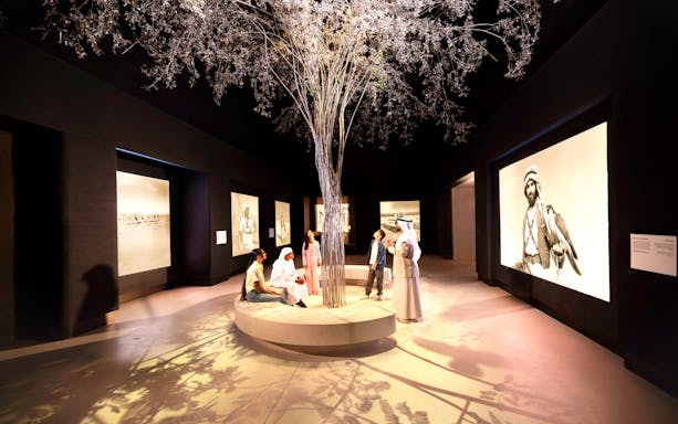 Visitors observing exhibits at the beginning exhibit, Zayed National Museum, Abu Dhabi.